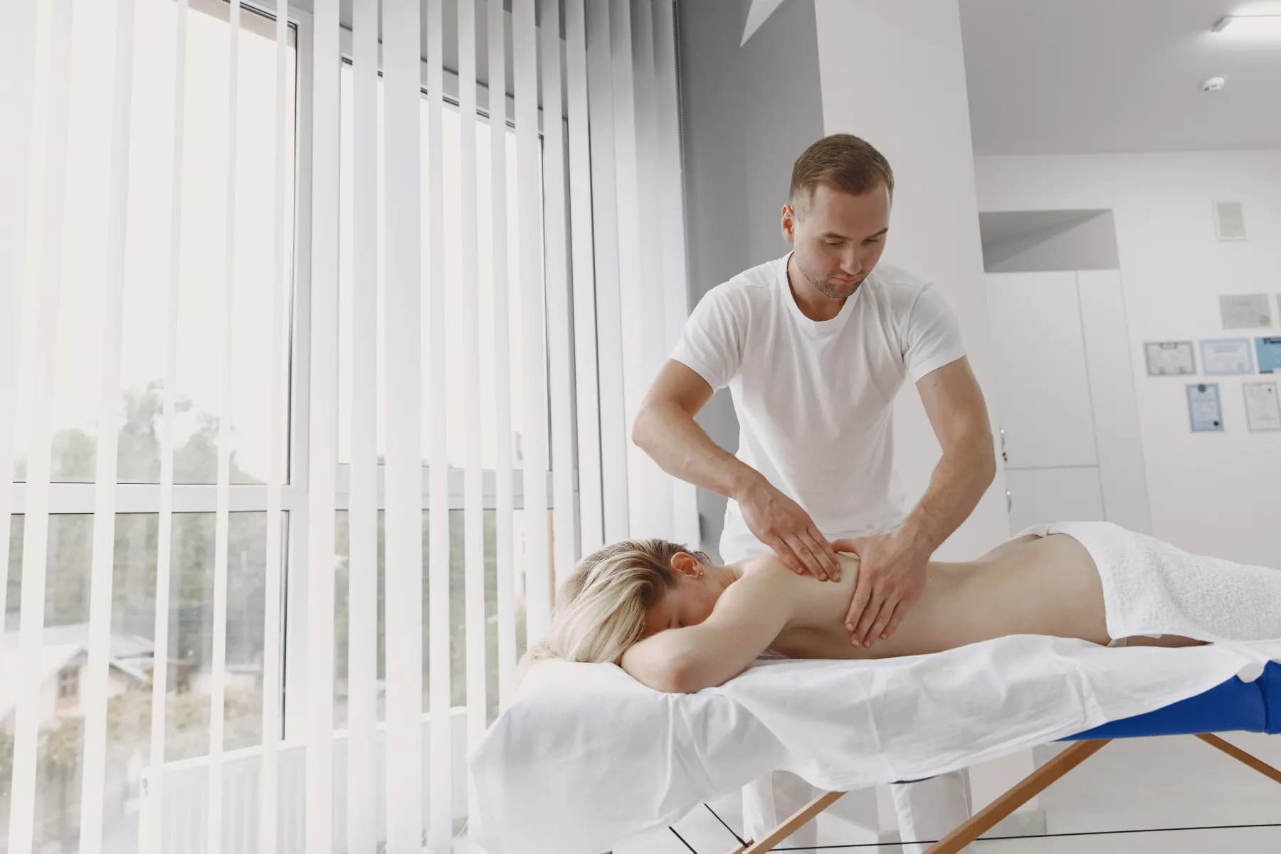 A clinical massage table made up and waiting in a quiet room